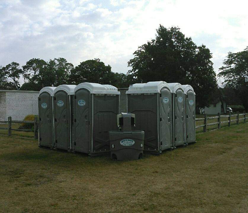 Six porta potties and a hand-washing sink are shown on Presque Isle Peninsula State Park in Erie, PA.